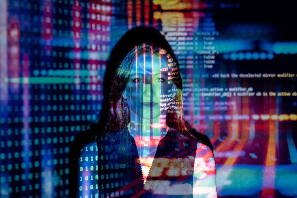 Image of a woman with liine of codes projected onto - illustration for an article on translation by machines and humans on the Absolute Translations website.